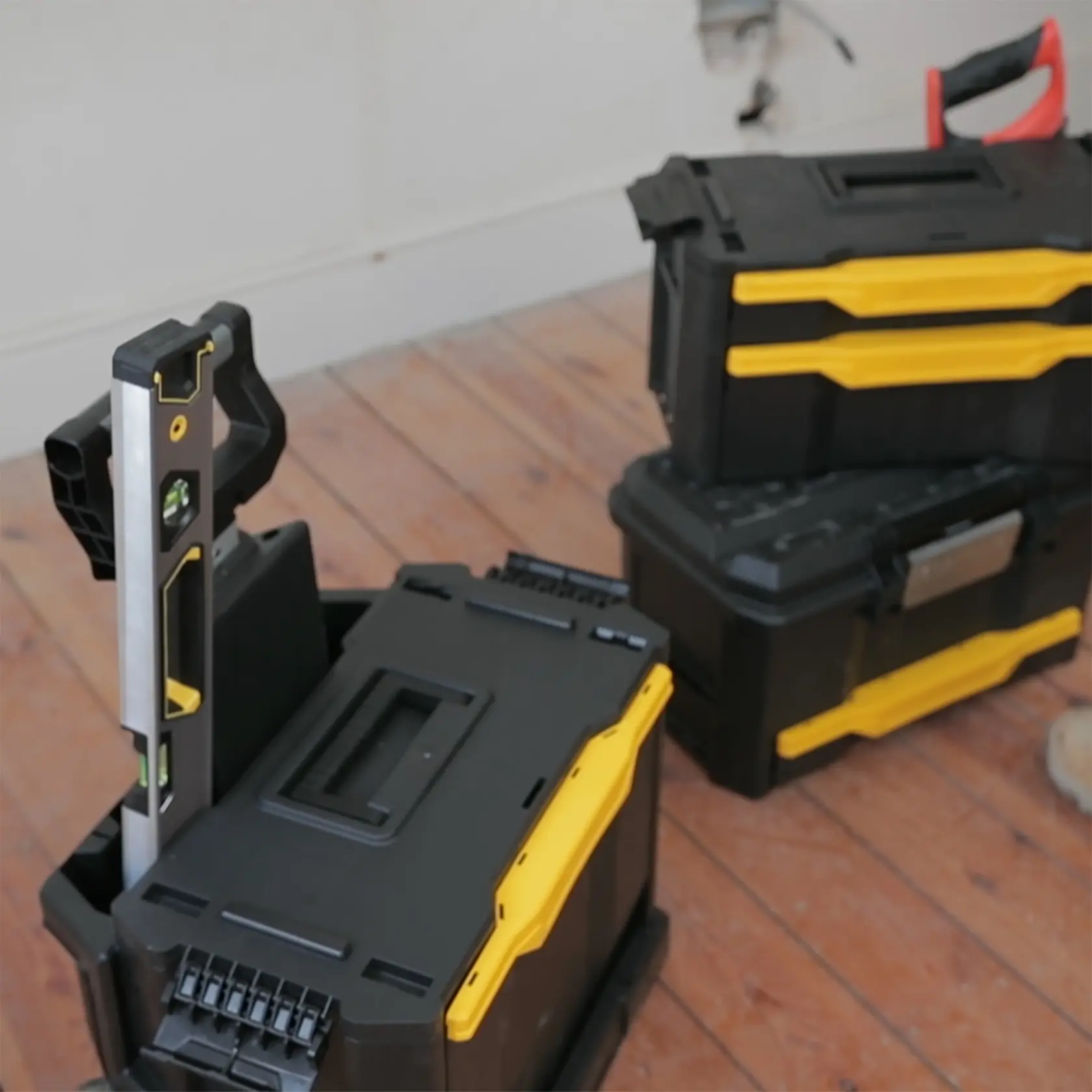 STANLEY 1-79-206 cassette per attrezzi impilabili nere e gialle con livello, angolo frontale, su pavimento in legno