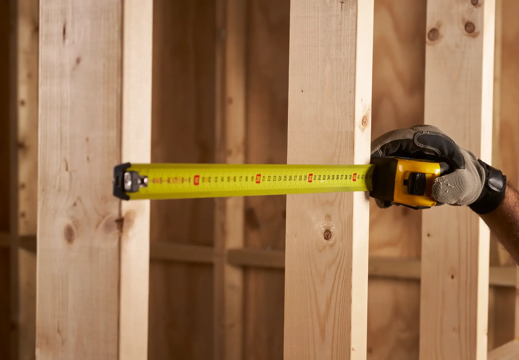 STANLEY FMHT0-33868 metro a nastro utilizzato per misurare montanti in legno, primo piano, contesto edile.